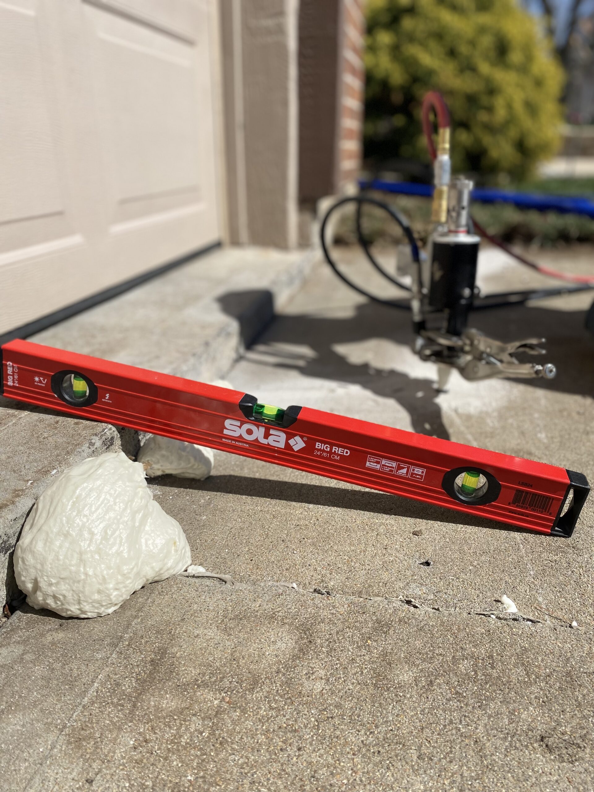 level showing uneven concrete with poly foam