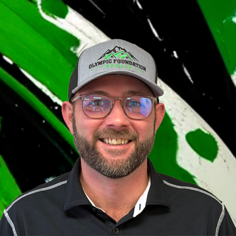Portrait of a smiling man wearing a gray cap with the Olympic Foundation Repair logo, and a black polo shirt, against a green abstract background.