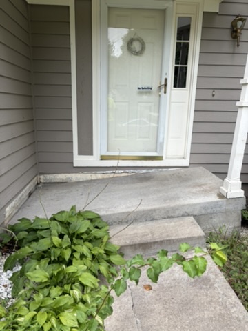 Front porch of a house that has severely suck