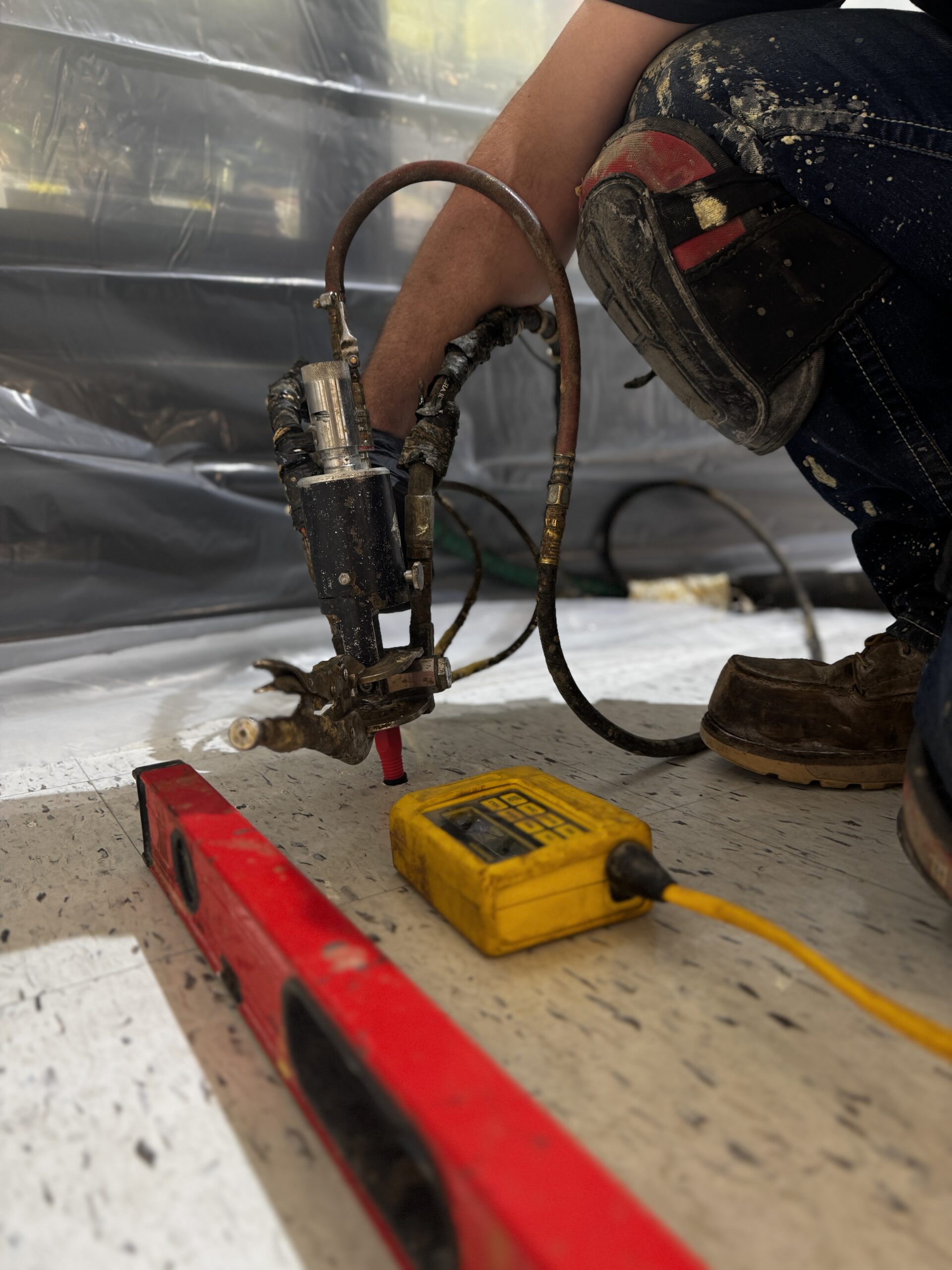 Shooting the foam beneath the slab with a level and ZipLevel